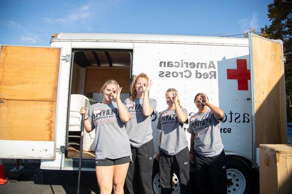 Students helping to clean up the Red Cross trailer as part of the Peayple in the Community Service Day.